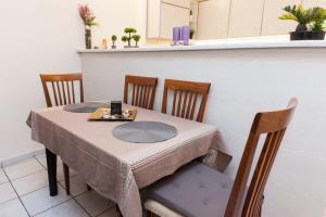 uma mesa com duas cadeiras e uma mesa com uma toalha de mesa em Delightful Modern 1 Bedroom Apartment in Kallithea em Atenas