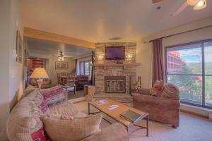 a living room with a couch and a fireplace at One BDR Ski in Ski Out Condo in Breckenridge