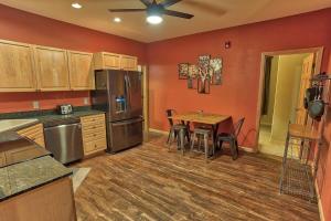 a large kitchen with a table and a refrigerator at Corral Hideaway Steps from Downtown in Breckenridge
