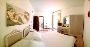 a bedroom with a bed and a sink and a mirror at Hotel Medusa in Lampedusa