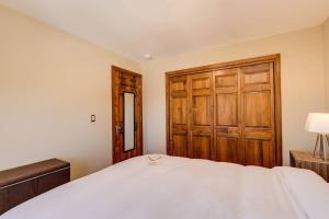 a bedroom with a bed and a wooden door at Cozy Red Roost Residence Essential Getaway in Breckenridge