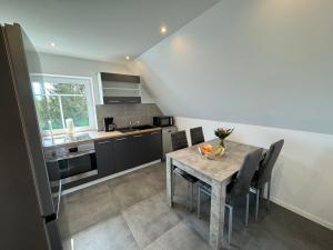a kitchen with a table with a bowl of fruit on it at Pension Jaeger in Achim