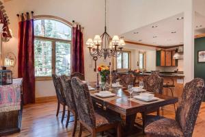 a dining room with a wooden table and chairs at Lazy Fox Lodge in National Forest View in Breckenridge