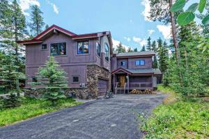a large wooden house with a driveway at Lazy Fox Lodge in National Forest View in Breckenridge