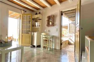 a kitchen with a table and a refrigerator at Design house on the beach in Rámos