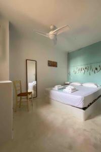 a bedroom with a bed and a ceiling fan at Design house on the beach in Rámos