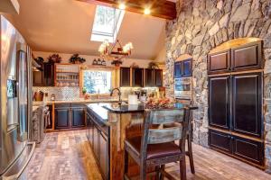 a kitchen with a large stone wall at Spacious Home with Hot Tub in Breckenridge