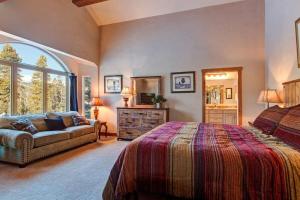a bedroom with a bed and a couch at Spacious Home with Hot Tub in Breckenridge