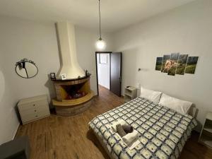 a bedroom with a bed and a fireplace at Paradise of Meteora A in Kastrákion