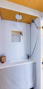 a bathroom with a shower on a white wall at HouseBoat Cagliari in Cagliari