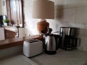 encimera de cocina con cafetera y lámpara en Gîtes Normands de charme les châtaigniers, en Bretteville-du-Grand Caux