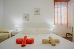 ein Schlafzimmer mit einem Bett mit drei Kissen darauf in der Unterkunft Casa Arianna, apartment a few steps from the sea in Marina di Mancaversa