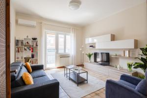 a living room with two blue couches and a tv at Casa Brando in Santa Maria delle Mole