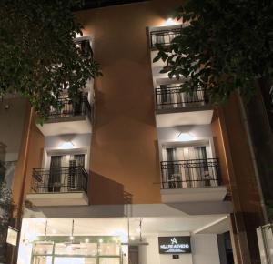 un edificio con balcones y una señal en él en Allure Athens Urban Suites, en Atenas
