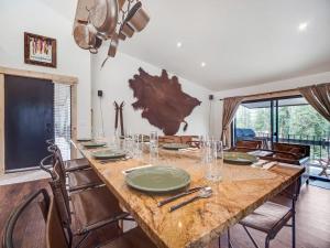 a dining room with a large wooden table with chairs at Cozy 2BR Condo Near Peak 8 and Town with Hot Tub Access in Breckenridge