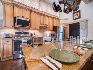 a large kitchen with wooden cabinets and a large counter top at Cozy 2BR Condo Near Peak 8 and Town with Hot Tub Access in Breckenridge