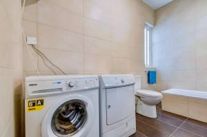 a bathroom with a washing machine and a toilet at Super Location, St Julians, 2 Bedroom, Paceville APT 7 by Vaganza in St Julian's +23 photos