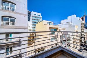 a balcony in the middle of buildings at Super Location, St Julians, 2 Bedroom, Paceville APT 7 by Vaganza in St Julian's
