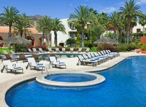 a swimming pool with lounge chairs and a resort at Loreto Bay Golf Resort & Spa at Baja in Loreto