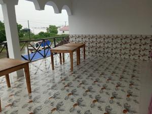 a room with two tables and a patterned floor at PM Lodge and Restaurent in Matemwe