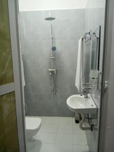 a bathroom with a shower and a toilet and a sink at PM Lodge and Restaurent in Matemwe
