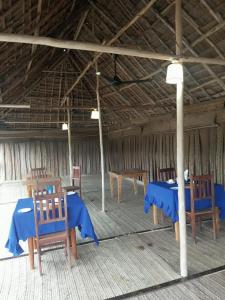 a room with blue tables and chairs in a building at PM Lodge and Restaurent in Matemwe