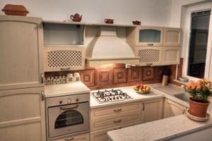 a kitchen with white cabinets and a stove top oven at Ferienwohnung für 4 Personen ca 100 qm in Dubrovnik-Babin Kuk, Dalmatien Süddalmatien in Dubrovnik