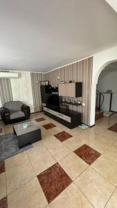a living room with a couch and a table at Villa Alex in Mamaia Nord