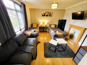 a living room with couches and a fireplace at Stay Sleep Rest - Santuary in Hull