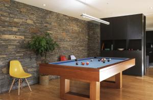 a billiards table in a room with a brick wall at Casa de l Cura in Miranda do Douro
