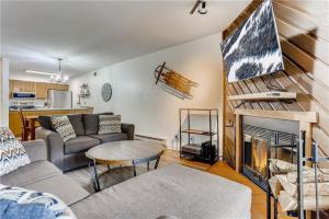 a living room with a couch and a fireplace at Lovely 2 BDR Condo Close to Skiing and Main St in Breckenridge