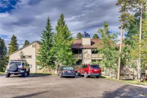 a house with two cars parked in a parking lot at Lovely 2 BDR Condo Close to Skiing and Main St in Breckenridge
