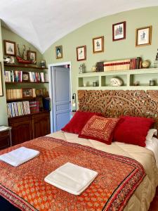 a bedroom with a large bed with red pillows at Domaine du Commandeur in Mondragon