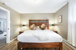 a bedroom with a large white bed with two lamps at Stunning 4 BR Home Mountain Views Tranquil Setting in Breckenridge
