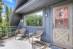 a front porch with two chairs and a door at Stunning 4 BR Home Mountain Views Tranquil Setting in Breckenridge