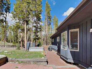 a side view of a black house with a patio at Stunning 4 BR Home Mountain Views Tranquil Setting in Breckenridge +32 photos
