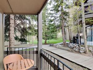 a balcony with a chair and a view of a yard at Stylish 2BR Home Near Skiing with Hot Tub Access in Breckenridge
