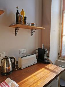 a kitchen counter with a toaster and a toaster oven at Gîte La Bancale in Lormes