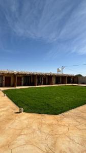 a building with a green lawn in front of it at سيال 1 in AlUla