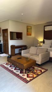 a living room with a couch and a coffee table at سيال 1 in Al-ʿUla