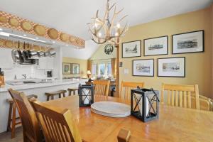 a dining room and kitchen with a table and chairs at Charming 2BR Condo in the Heart of Breckenridge in Breckenridge