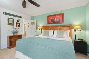 a bedroom with a large bed with blue walls at Charming 2BR Condo in the Heart of Breckenridge in Breckenridge