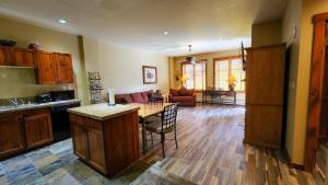 a kitchen with a table and a living room at Main St Station Condo with Hot Tub and Parking in Breckenridge