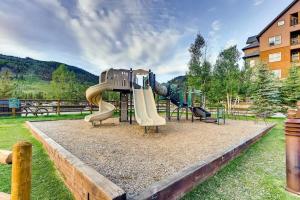a playground with a slide in a park at 2BR Ski In Ski Out Keystone Condo Walk to Slopes in Dillon
