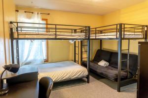 ブリッケンリッジにあるMain St 2BR Next to Ski Accessの二段ベッド2台とソファのある寝室