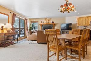 a living room with a wooden table and chairs at Cozy Ski In Ski Out Walk to Main St in Breckenridge