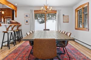 a dining room with a wooden table and chairs at Serene 3BD with Stunning Views and Hot Tub in Breckenridge