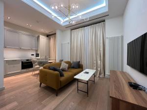 a living room with a couch and a kitchen at ARP_apartments in Baku