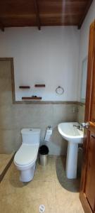 ein Bad mit einem WC und einem Waschbecken in der Unterkunft VILLA FLOREANA in Puerto Velasco Ibarra