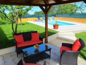 a patio with chairs and a table and a pool at Ferienhaus mit Privatpool für 6 Personen ca 90 qm in Sveti Petar u Sumi, Istrien Binnenland von Istrien in Sveti Petar u Šumi